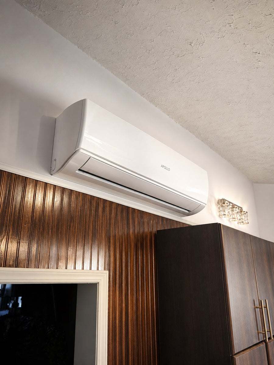 Apollo 3 ton wall fan coil installed above dark wood kitchen cabinets.