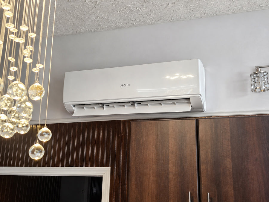 Apollo 3 ton wall fan coil with open louvers installed above kitchen cabinets.